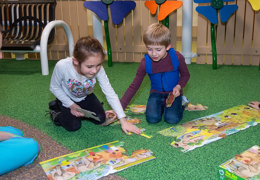 Two children participating in therapy session at Reid Pediatric Rehabilitation Services