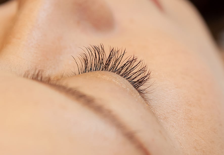 A close-up view of a woman's closed eyes