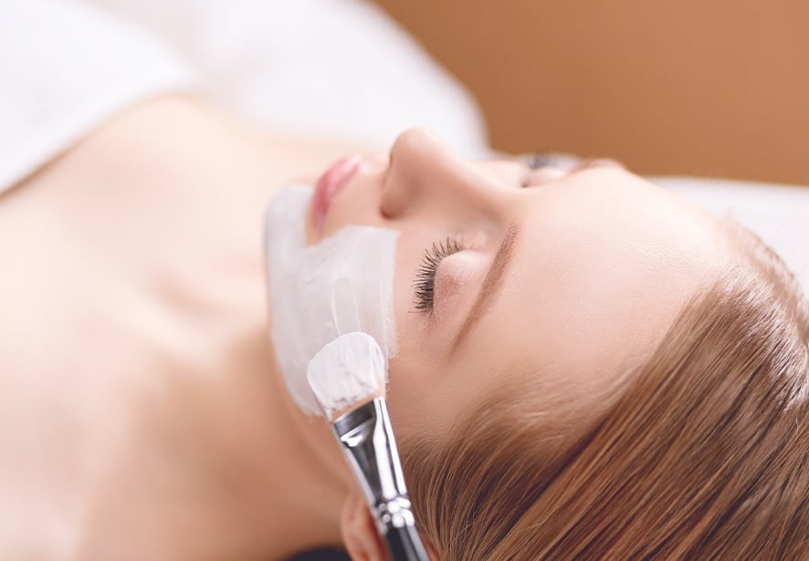 An image of a women receiving a facial 