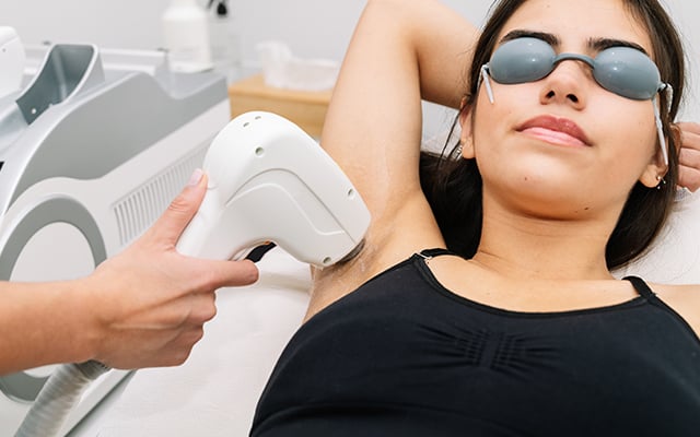 A woman receiving a laser hair removal procedure 