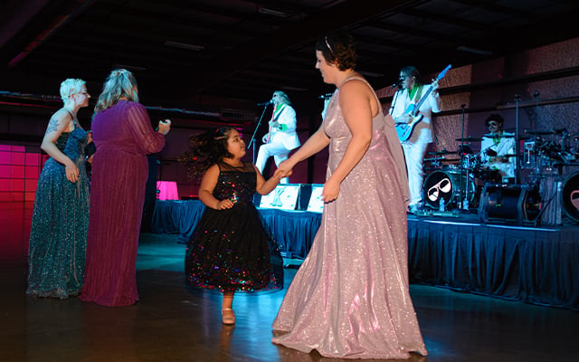 A Reid Health cancer patient dancing with her daughter at Kaleidoscope