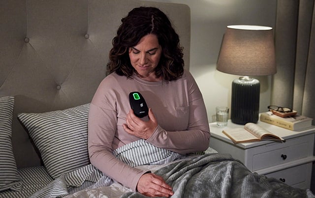 A women using the Inspire remote for their treatment option