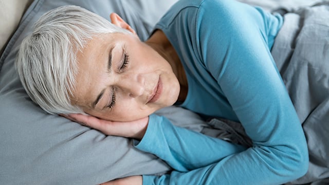 A woman sleeping peacefully in her bed