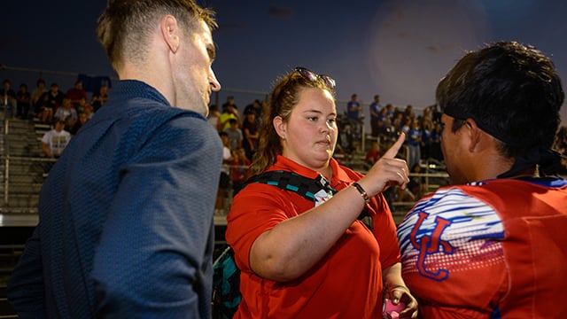 Reid Health Athletic Trainer Dorothy Tyo and Dr. Connor Hoban evaulating a football for a concussion