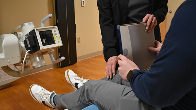 A patient having a knee x-ray taken at Ortho Walk-In Now Greenville