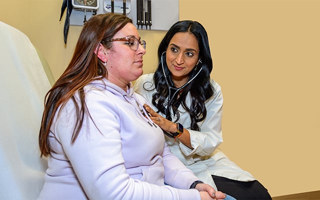 Perioperative Care doctor, Annuradha Bhandari, MD caring for a patient during an appointment.