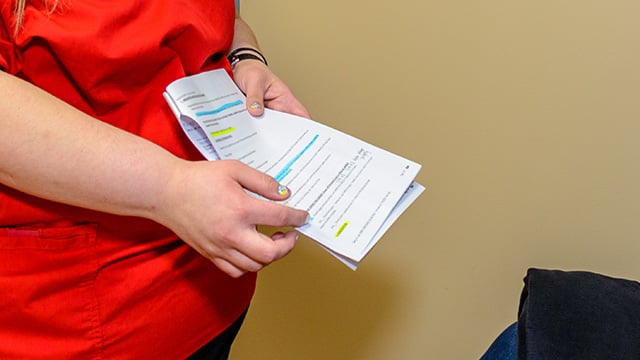 A Reid Health team member showing a patient important prep information