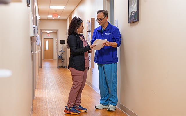 Dr. Aaron Johnson reviewing information with one of the Urology nurses. 