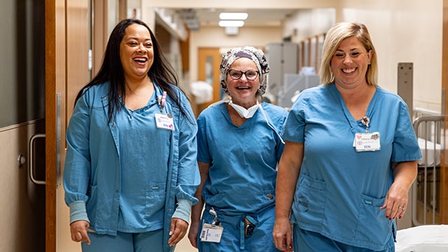 Dr. Janelle Evans and two nurses walking down the hall together