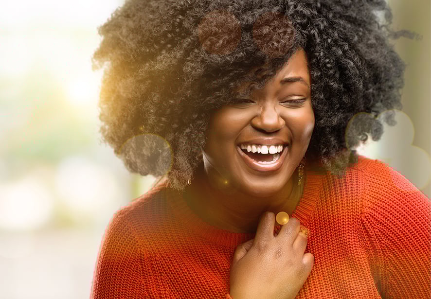 A African American women in a red sweater smiling 
