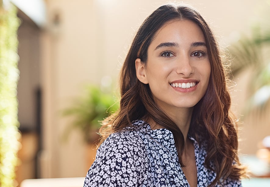 A Hispanic woman outside smiling