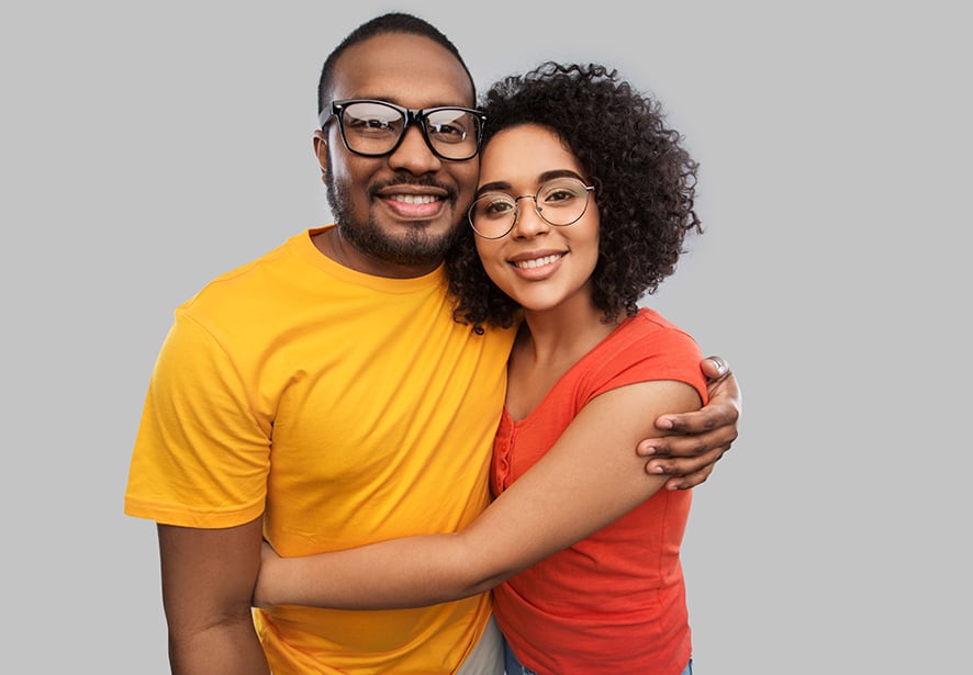 happy african american couple in glasses hugging 