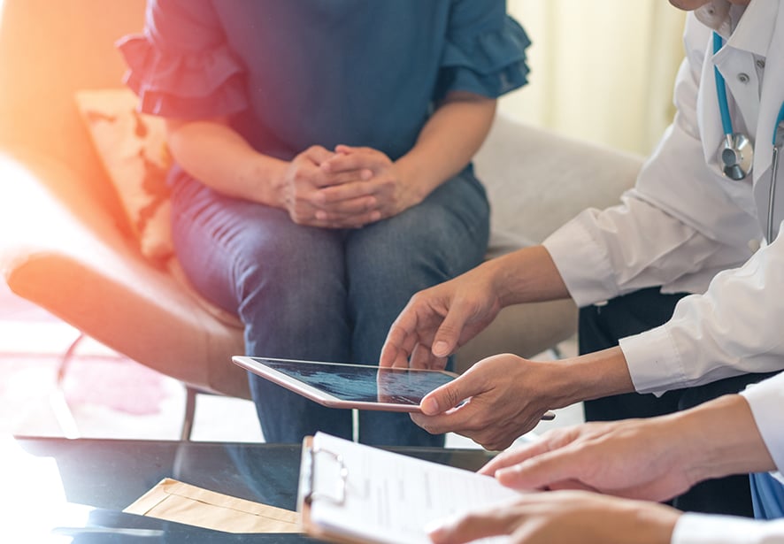 physician team consulting with a woman patient 