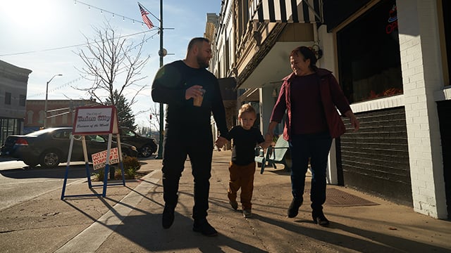 A family walking down the street together 