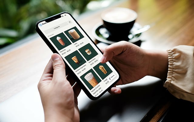 An image of someone using their phone using the order ahead option