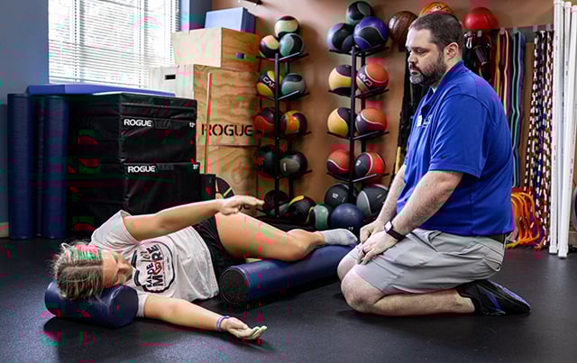 Trey Hollar, AT-C working with a student athlete in the Athletic Training Clinc