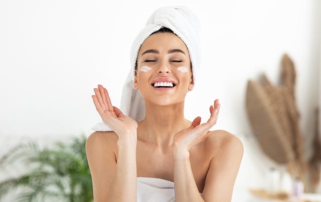 An image of a woman smiling during a spa visit 