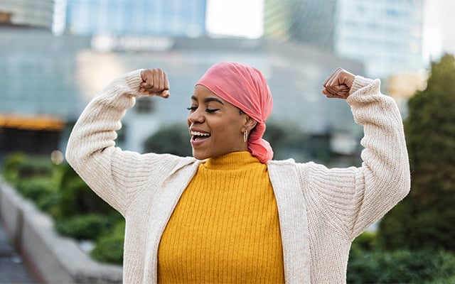 A woman raising her arms in a display strength 