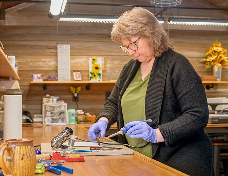 Mary Burk, working in her home studio, She Shed Glass Studio LLC