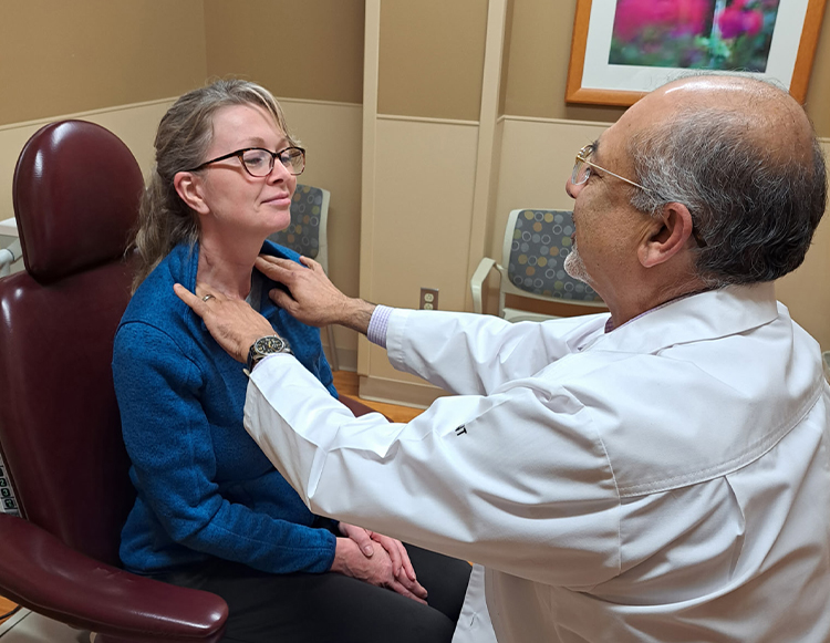 Rohit Bawa, MD preforming a head and neck screening on a patient