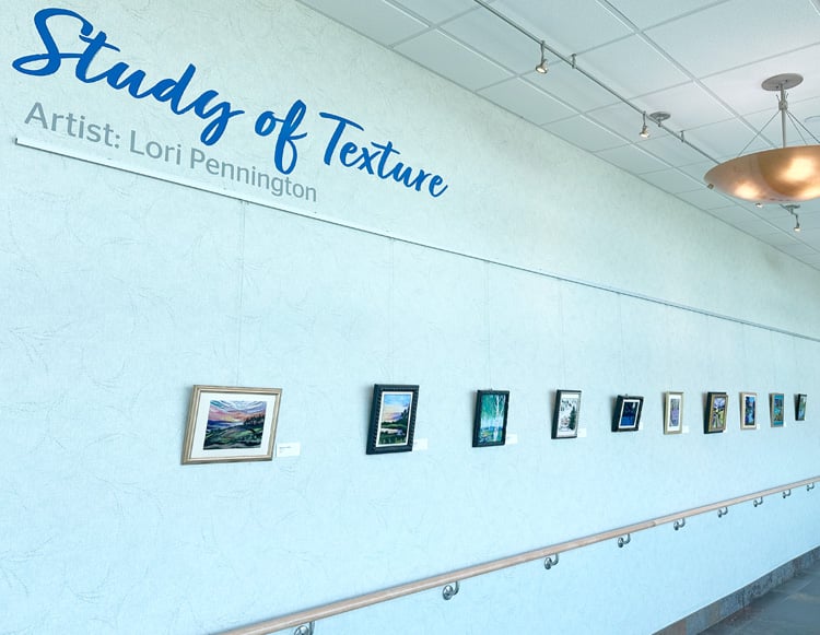 Photo of the MacDowell Gallery hallway at Reid Health showing Artwork by Lori Pennington