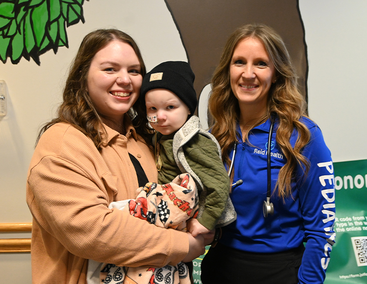 Olivia and Zach Bryant posing with the January 2026 Daisy Winner, Emily Selby an LPN, at Whitewater Valley Primary Care in Connersville
