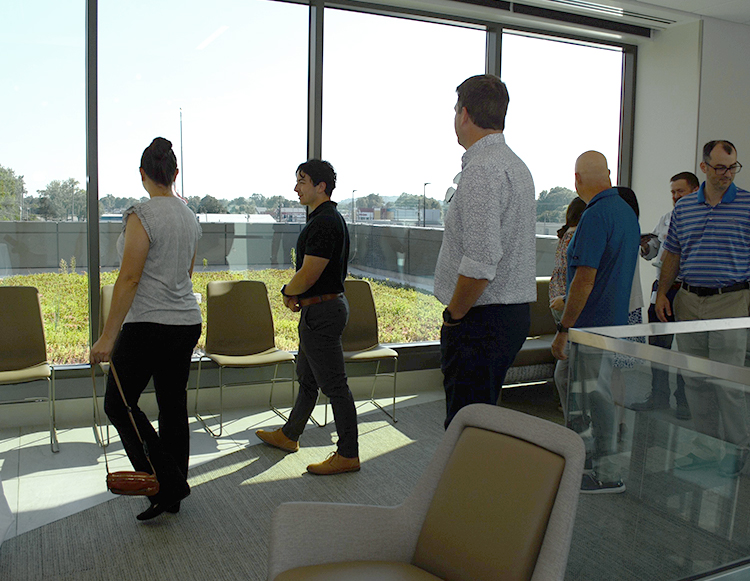 A group of people looking out at the green roof at Reid Health Connersville, named after Dave Rogers.