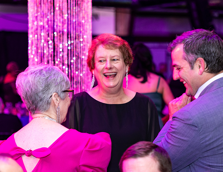 Robin Hemry smiling while talking with other at Reid Health Signature Event, Kaleidoscope
