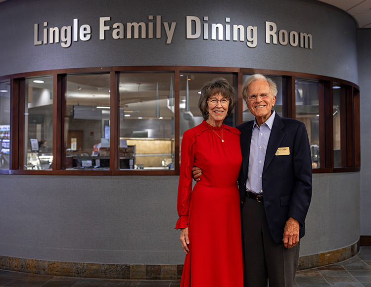 Paul and Pat Lingle posing in front of the Lingle Family Dining Room named space
