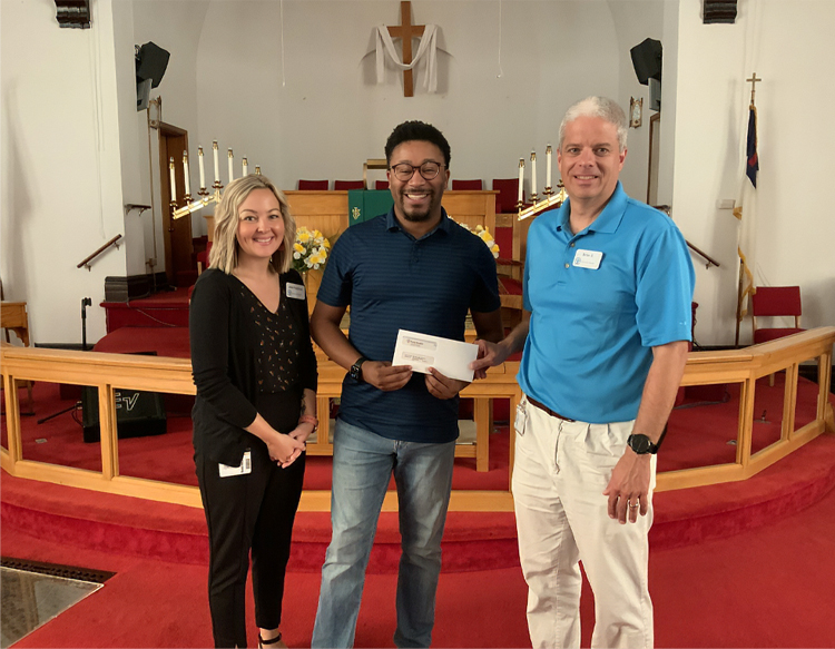 Reverend Michael Jefferson of Bethel African Methodist Episcopal Church is presented with a check from Reid Health Community 
