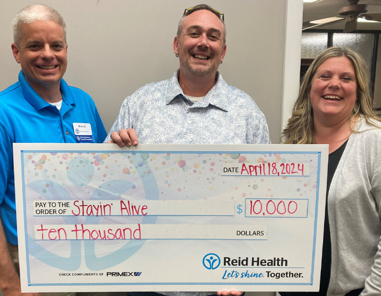 Reid Health Community Benefit presenting a check to Stayin' Alive