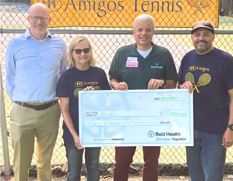 Reid Health Community Health presenting a check to Amigos Tennis 