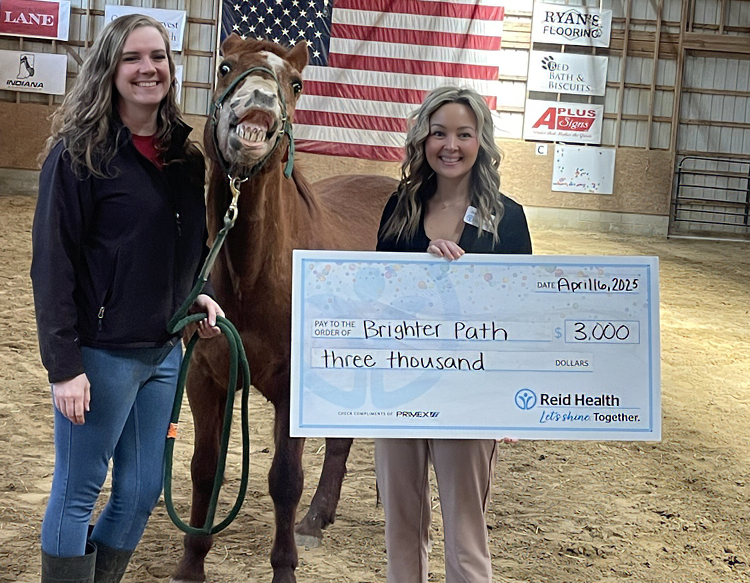 Reid Health Community Engagement presenting a check to Brighter Path Inc.