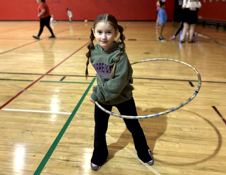  A photo provided by Girls Inc. of a young girl holding a hula-hoop