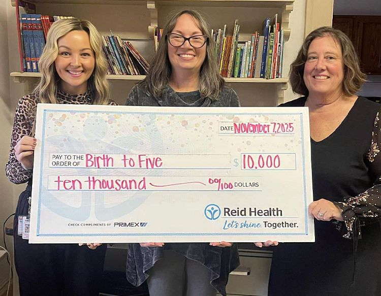 Reid Health Community Engagement presenting a check to Birth To Five