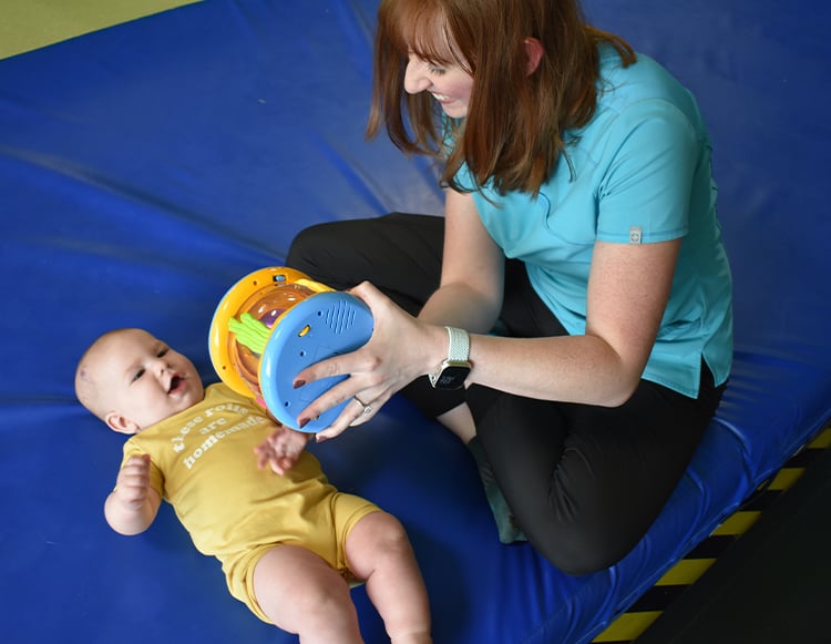 Reid Health pediatric patient, Kolson Brown during a physical therapy session.
