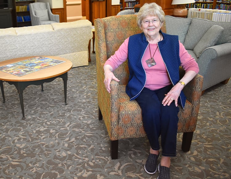 Jan Bohlander sitting in a chair at Friends Fellowship smiling