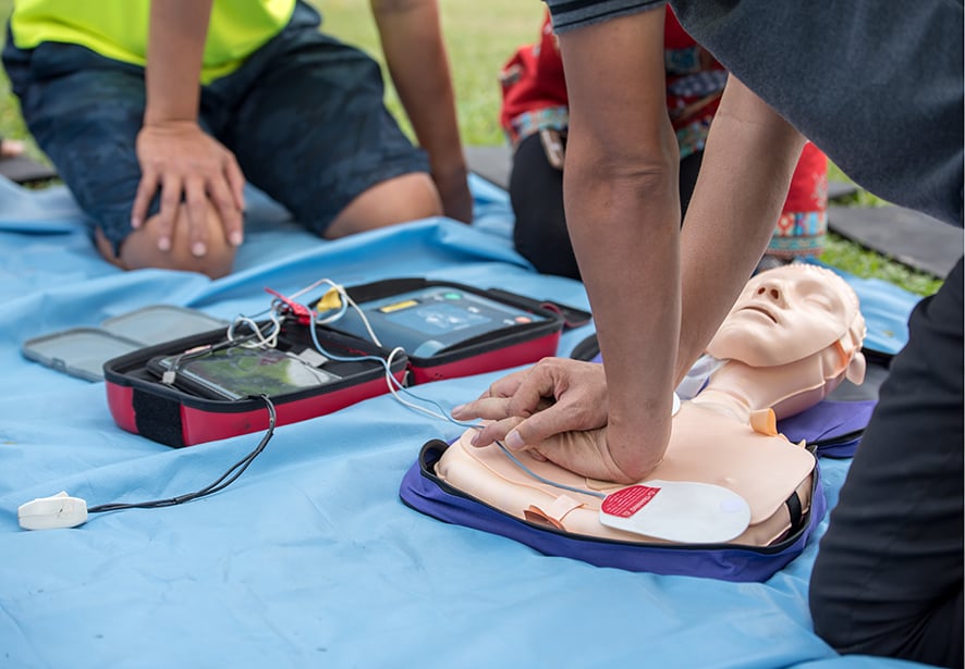 A person learning CPR compressions