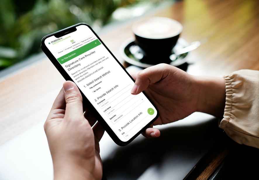 A person using a cell phone searching the network provider directory