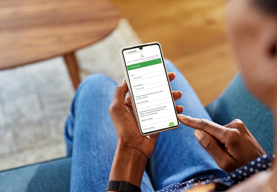 A person using a cell phone showing the form you to fill out 