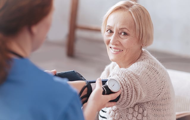 A woman having her blood pressure taken