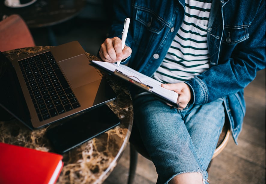 An image of a person taking a paper survey 