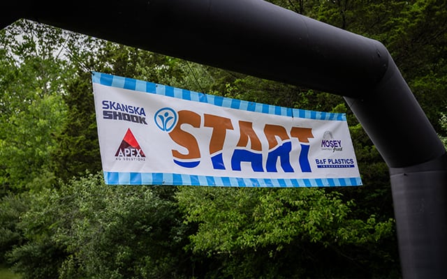 The start line of the Reid Adventure Course 2026 with a banners showing Skansak Shook,. Apex Ag Solutions, Mosey Charitable Funda and B & F plastics logos on it.