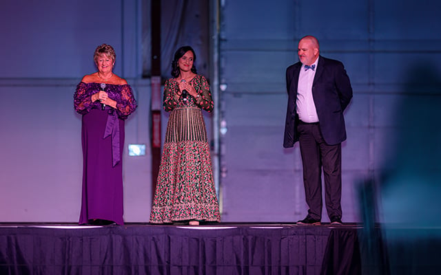 Left to right, Ann Brooks, Annuradha Bhandari, MD, and Jeremy Duncan on stage speaking to the crowd at Reid Health's Foundation signature event Kaleidoscope