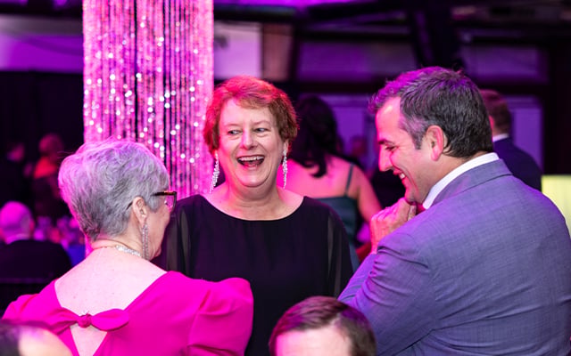 Robin Hemry smiling while talking with other at Reid Health Signature Event, Kaleidoscope 