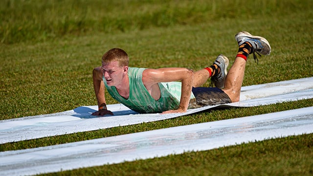 A participated at the Reid Adventure Course going down the slip and slide
