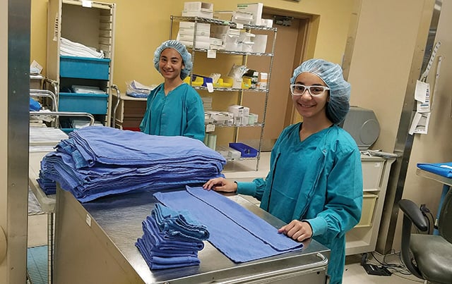 Two junior volunteers working in sterile processing 