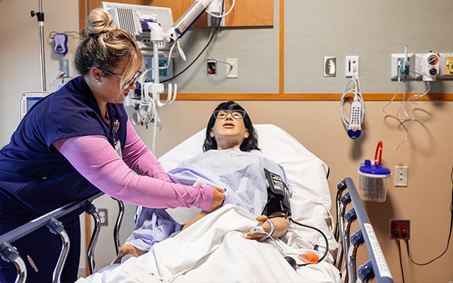 A Reid Health nurse working on her skills in the SIM lab
