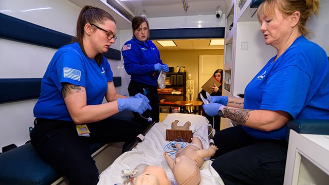 EMS students working in the ambulance simulator 