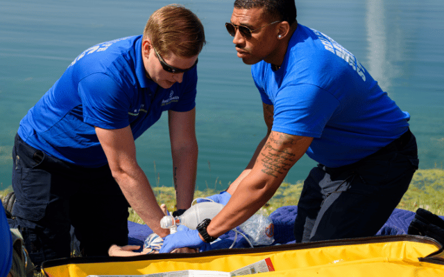Photo shows two paramedic cohort students part of Reid Health EMS Training Institute performing a water rescue exercise on a dummy. 